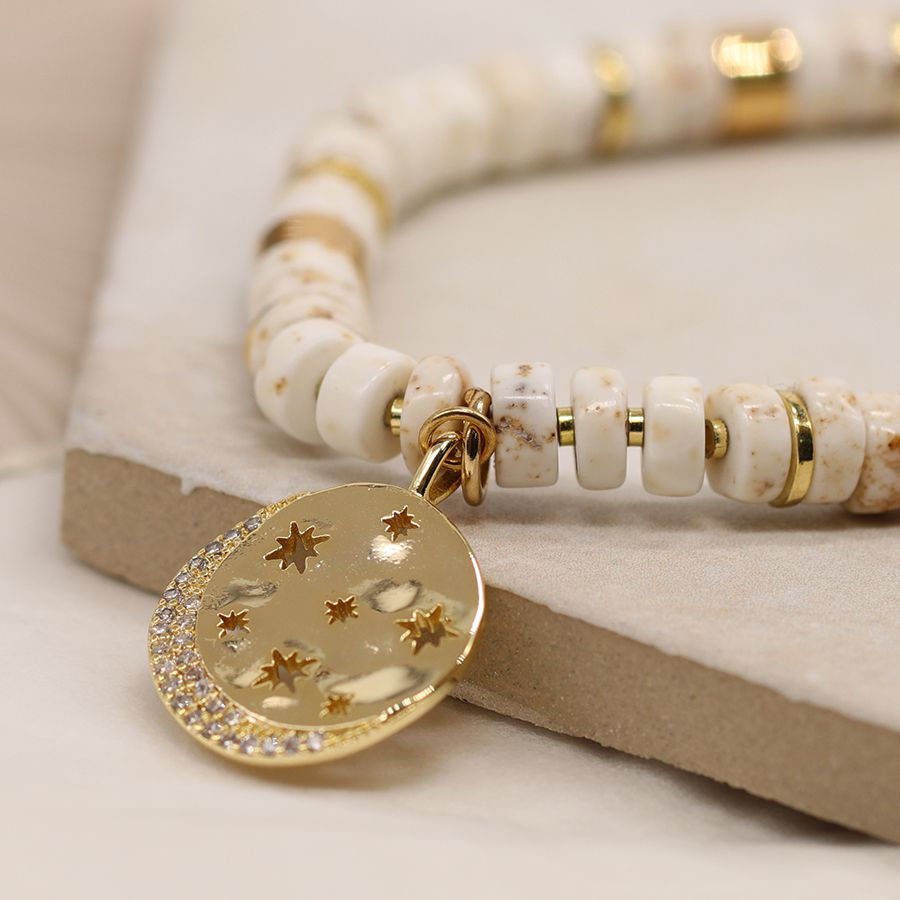 POM White Semi Precious Bead Stretch Bracelet with Gold Cut out Disc Charm